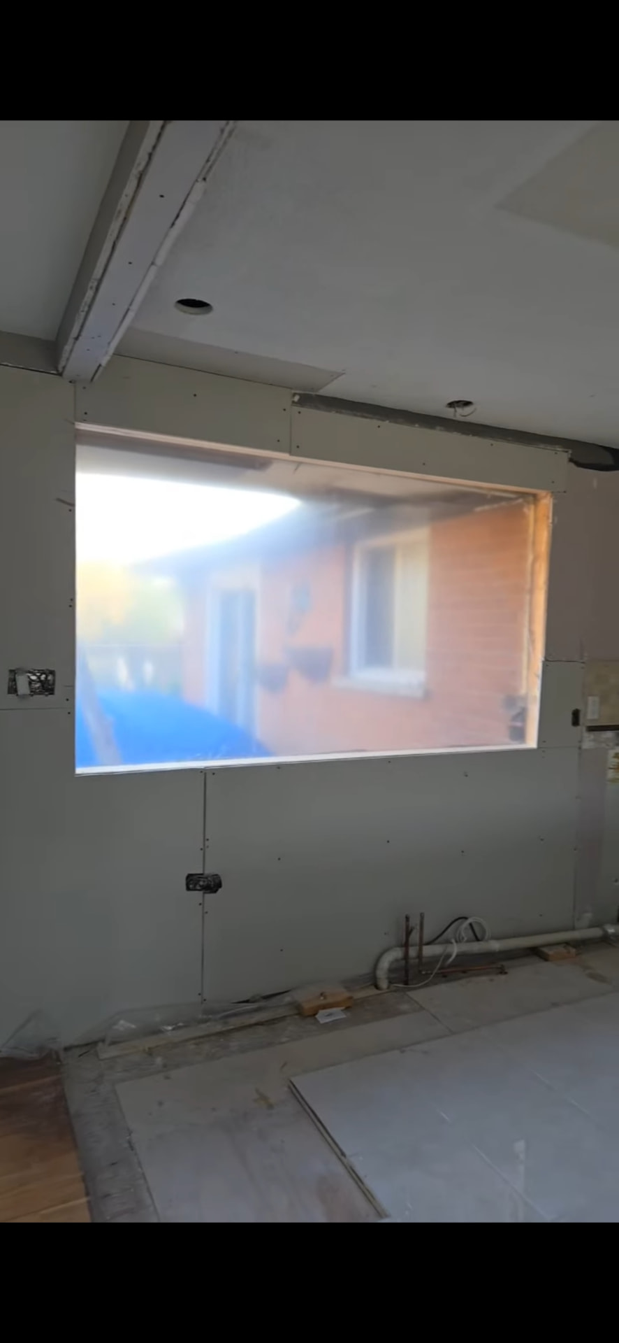 New pass-through opening framed and drywalled between the kitchen and dining area