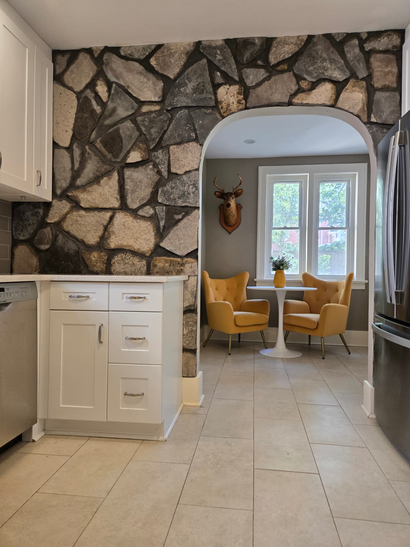 Finished natural stone feature wall wrapping the kitchen archway into the breakfast nook